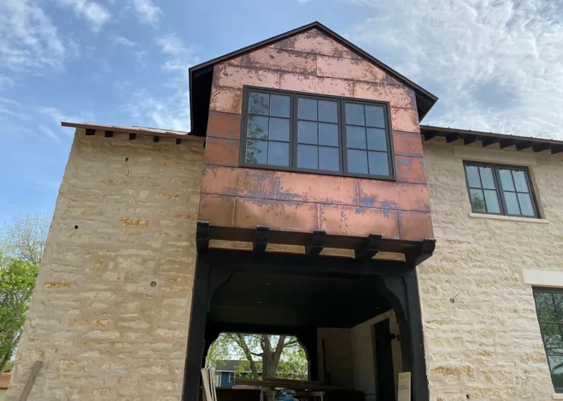 Copper metal panel facade on a stone building for Roof Repair in Castroville