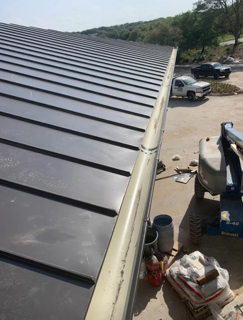 Standing seam panel and gutter detail on a metal roofing jobsite in Castroville